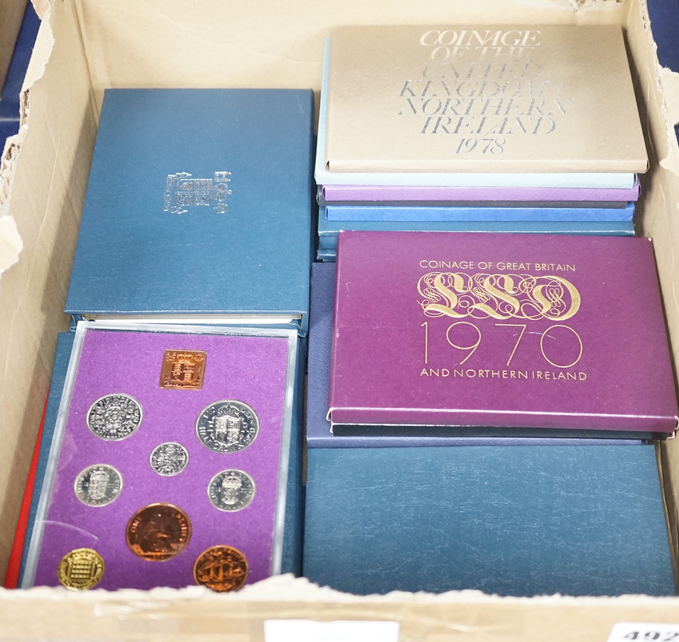 Twenty two cased Royal Mint UK proof coin year sets 1970-76, 1978-1989 including 1986 x 2, 1987 x 2, 1970 x 2, together with a 1953 BUNC set (23)